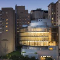 A lit-up CUIMC building at night.